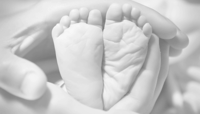 baby feet inside hands